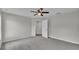 This bedroom has carpet, gray walls, a ceiling fan, and an open doorway at 420 Tecumseh N Ave, Fort Meade, FL 33841