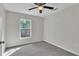 Cozy bedroom featuring plush carpet, neutral walls, and a ceiling fan at 420 Tecumseh N Ave, Fort Meade, FL 33841