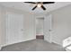 Comfortable bedroom featuring carpet flooring, neutral walls, a ceiling fan, and closet at 420 Tecumseh N Ave, Fort Meade, FL 33841