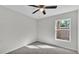 Bright bedroom with neutral walls, plush carpet, and a ceiling fan at 420 Tecumseh N Ave, Fort Meade, FL 33841