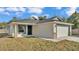 A single-story home featuring an attached two-car garage and a well-manicured front lawn at 420 Tecumseh N Ave, Fort Meade, FL 33841