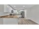 Bright kitchen featuring stainless steel appliances, countertops, and access to the adjacent living area at 420 Tecumseh N Ave, Fort Meade, FL 33841
