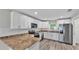 Well-lit kitchen features stainless steel appliances, sleek white cabinetry, and stylish countertops at 420 Tecumseh N Ave, Fort Meade, FL 33841