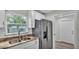 Close-up of a modern kitchen featuring stainless steel appliances and stone countertops at 420 Tecumseh N Ave, Fort Meade, FL 33841