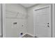 This laundry room has gray walls, wood look flooring, and a wire shelf for storage at 420 Tecumseh N Ave, Fort Meade, FL 33841