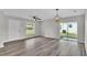 Bright living room featuring wood floors, contemporary lighting, and sliding glass doors to the backyard at 420 Tecumseh N Ave, Fort Meade, FL 33841
