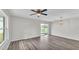 Living room with wood floors, ceiling fan, and sliding doors opening to an outdoor space at 420 Tecumseh N Ave, Fort Meade, FL 33841