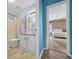 Bright bathroom with a vanity, shower-tub combination and blue accent wall at 1717 Lilly Ln, Lady Lake, FL 32159