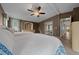 Cozy bedroom featuring two beds, large window with blinds, and a ceiling fan at 1717 Lilly Ln, Lady Lake, FL 32159