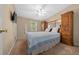 Charming bedroom featuring a queen bed, built-in wood cabinets, and plenty of natural light at 1717 Lilly Ln, Lady Lake, FL 32159