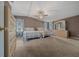 Spacious bedroom with two beds, dresser, ceiling fan and light-filled windows at 1717 Lilly Ln, Lady Lake, FL 32159