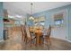 Dining room with wooden table, with kitchen in background, and outside access at 1717 Lilly Ln, Lady Lake, FL 32159