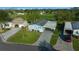 Aerial view of a charming blue home with a carport and manicured lawn at 1717 Lilly Ln, Lady Lake, FL 32159