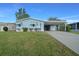 A beautiful house and lawn with vibrant green grass at 1717 Lilly Ln, Lady Lake, FL 32159
