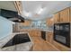 Spacious kitchen with ample counter space, modern appliances, and wood-style flooring at 1717 Lilly Ln, Lady Lake, FL 32159