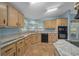 Bright kitchen featuring ample counter space, stainless steel appliances, and wood-style floors at 1717 Lilly Ln, Lady Lake, FL 32159