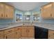 Bright kitchen featuring ample counter space, stainless steel sink, and black appliances at 1717 Lilly Ln, Lady Lake, FL 32159