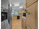 Kitchen featuring stainless steel refrigerator, granite countertops, and light wood cabinetry at 1717 Lilly Ln, Lady Lake, FL 32159