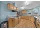 Bright kitchen featuring ample counter space, stainless steel appliances, and wood-style floors at 1717 Lilly Ln, Lady Lake, FL 32159