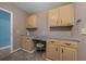 Bright laundry room featuring desk space, cabinetry, and tile floor at 1717 Lilly Ln, Lady Lake, FL 32159