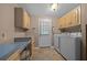 Bright laundry room equipped with counter space, overhead cabinets, and a washer and dryer at 1717 Lilly Ln, Lady Lake, FL 32159