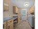 Convenient laundry room with ample counter space, cabinetry, and modern washer and dryer at 1717 Lilly Ln, Lady Lake, FL 32159