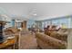 Bright, open-concept living room with ample natural light, lots of seating and outdoor views at 1717 Lilly Ln, Lady Lake, FL 32159