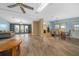 Open living and dining areas with wood floors, natural light, and an open flow to the kitchen at 1717 Lilly Ln, Lady Lake, FL 32159