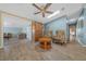 Living room featuring wood floors, skylight, ceiling fan, and an open layout to other living areas at 1717 Lilly Ln, Lady Lake, FL 32159