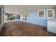 Spacious covered patio with wood flooring and a calming blue exterior at 1717 Lilly Ln, Lady Lake, FL 32159
