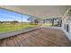 A light and airy patio with screens showcasing a golf course view at 1717 Lilly Ln, Lady Lake, FL 32159