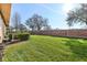 Spacious backyard with lush green lawn and a brick wall, perfect for outdoor activities at 2938 Rodrick Cir, Orlando, FL 32824