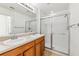 Bright bathroom with double sink vanity and glass enclosed shower at 2938 Rodrick Cir, Orlando, FL 32824