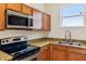 Updated kitchen featuring granite counters, stainless steel appliances, and natural light at 2938 Rodrick Cir, Orlando, FL 32824