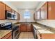 Well-lit kitchen featuring stainless steel appliances, sleek cabinetry, and plenty of counter space at 2938 Rodrick Cir, Orlando, FL 32824
