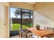 Enclosed patio with a wooden dining set offers a relaxing outdoor space, perfect for enjoying meals and fresh air at 2938 Rodrick Cir, Orlando, FL 32824