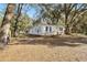 A single-story home features a ramp to the front door and mature trees at 3925 Ne 92Nd Pl, Anthony, FL 32617