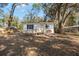 A quaint home boasts a yard with mature trees and ramp to the front door at 3925 Ne 92Nd Pl, Anthony, FL 32617