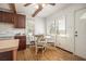 Bright eat-in kitchen features a glass table, wood floors, and a view of the backyard at 3925 Ne 92Nd Pl, Anthony, FL 32617