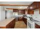 A well-equipped kitchen featuring granite counters, stainless steel refrigerator, and wood floors at 3925 Ne 92Nd Pl, Anthony, FL 32617