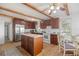 Spacious kitchen with dark wood cabinets, stainless steel appliances, and wood flooring at 3925 Ne 92Nd Pl, Anthony, FL 32617