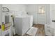 Laundry area featuring a washer and dryer, water heater, and access to outside at 3925 Ne 92Nd Pl, Anthony, FL 32617