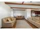 Open living room showcasing wood beam ceilings, hardwood floors, and ample seating at 3925 Ne 92Nd Pl, Anthony, FL 32617