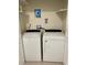 A clean, well-organized laundry area with white washer and dryer set and utility connections at 5977 Wallace Dr, Orlando, FL 32807