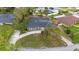 Overhead view of the home featuring a large yard, convenient driveway, and inviting screened-in pool, blending comfort and leisure at 12 Lake Link Dr, Winter Haven, FL 33884