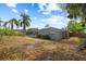 Backyard view featuring the house exterior, swimming pool and screen enclosure at 12 Lake Link Dr, Winter Haven, FL 33884