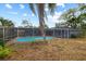 Backyard view showcasing the pool and enclosed patio area at 12 Lake Link Dr, Winter Haven, FL 33884