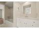 Bathroom featuring a shower-tub combo and vanity with white marble countertop at 12 Lake Link Dr, Winter Haven, FL 33884