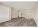 Light-filled bedroom with wood-look flooring and a door leading to the ensuite bath at 12 Lake Link Dr, Winter Haven, FL 33884