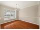 Bright dining room features hardwood floors, natural light and chandelier fixture at 12 Lake Link Dr, Winter Haven, FL 33884